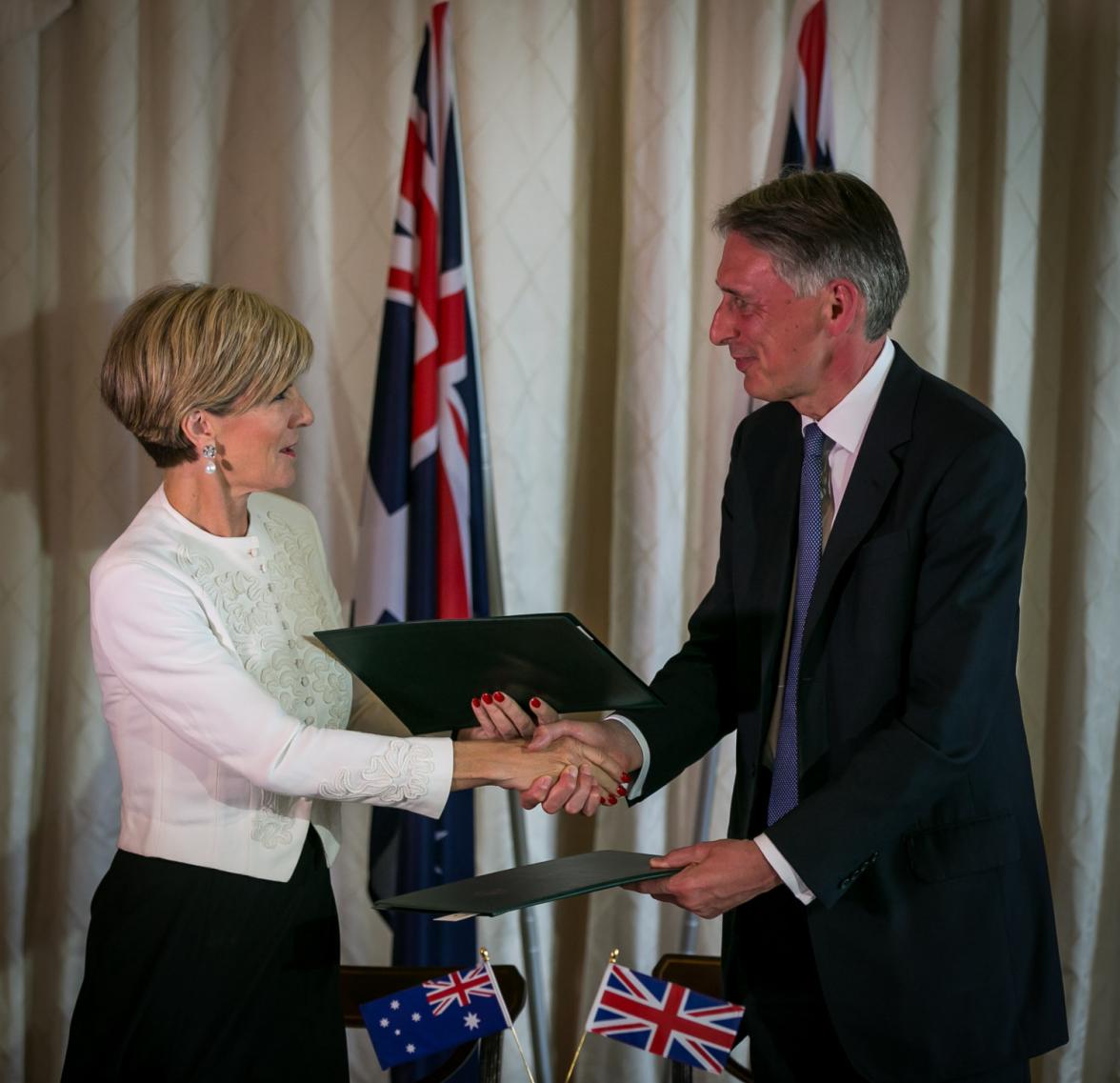 Foreign Minister Julie Bishop and Foreign Secretary Hammond shake hands after signing an MoU on crisis cooperation. 2 February 2015.