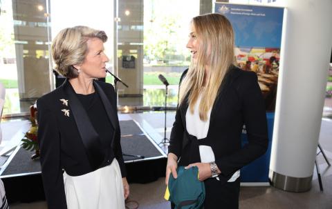 Foreign Minister Bishop with Ellyse Perry as she presents an autographed Australian Women's Cricket shirt at the Welcome Reception for the Ambassador for Women & Girls, Natasha Stott Despoja. 3 March 2014.