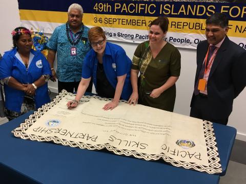 Australian Minister for Foreign Affairs, Senator the Hon Marise Payne signing the Pacific Skills Partnership tapa with Nauruan Minister for Education, the Hon Charmaine Scotty MP, and Soli Middleby, CEO, Australia Pacific Training Coalition.