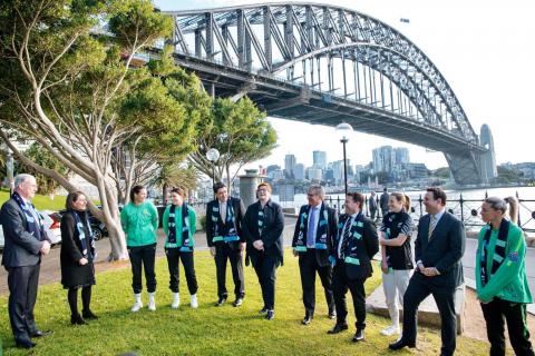 Group photo of attendees at the press conference under the Sydney Harbour Bridge.