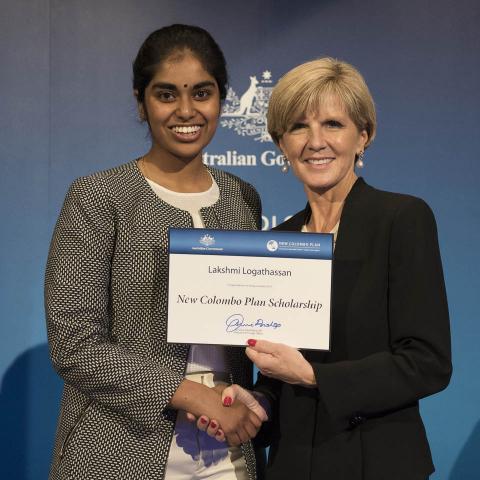Minister Bishop presenting Lakshmi Logathassan UWS studying in Singapore