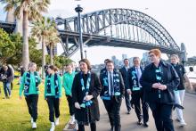 Group photo of attendees following the press conference under the Sydney Harbour Bridge.